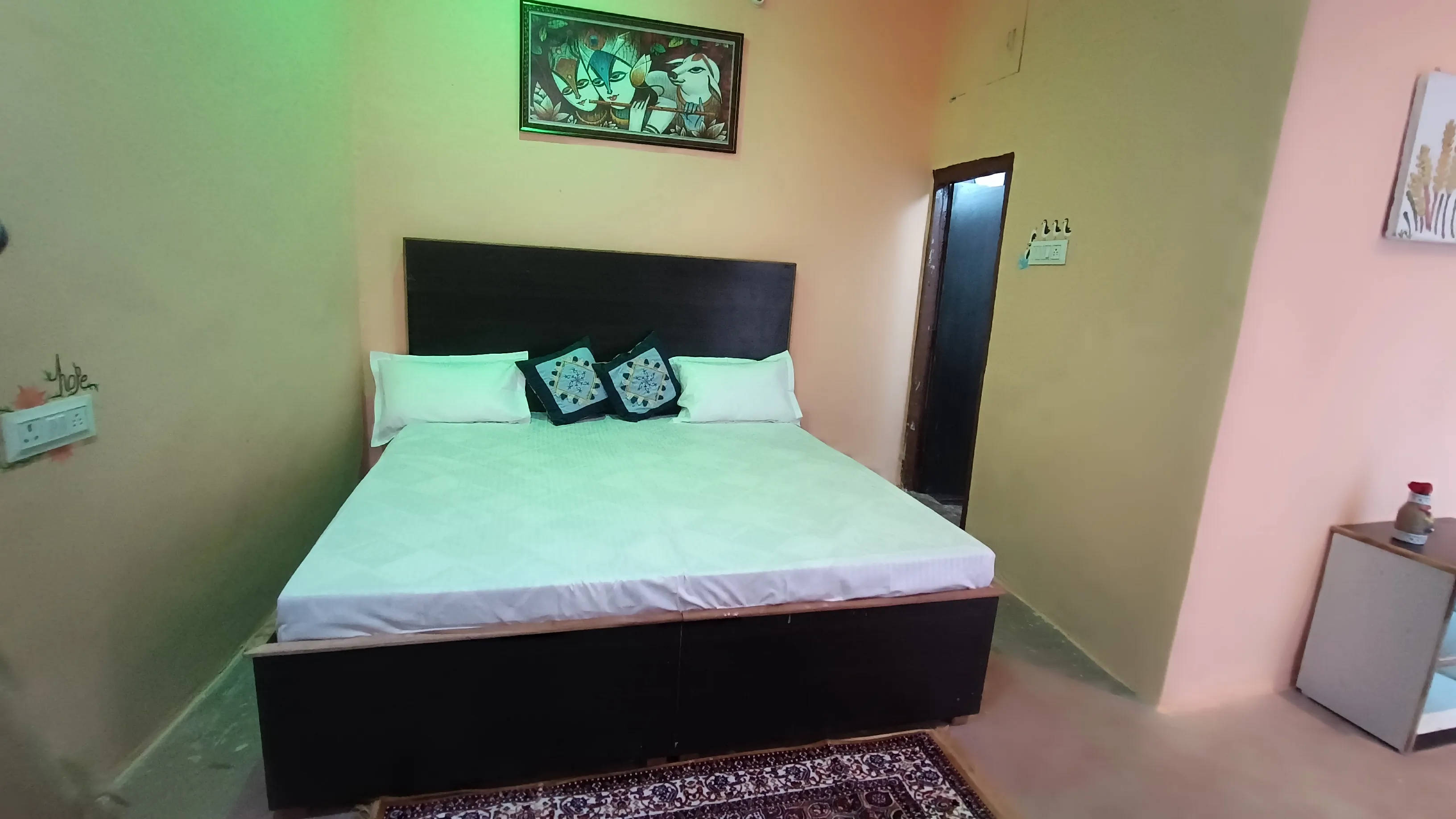 A second front view of the made-up double bed.