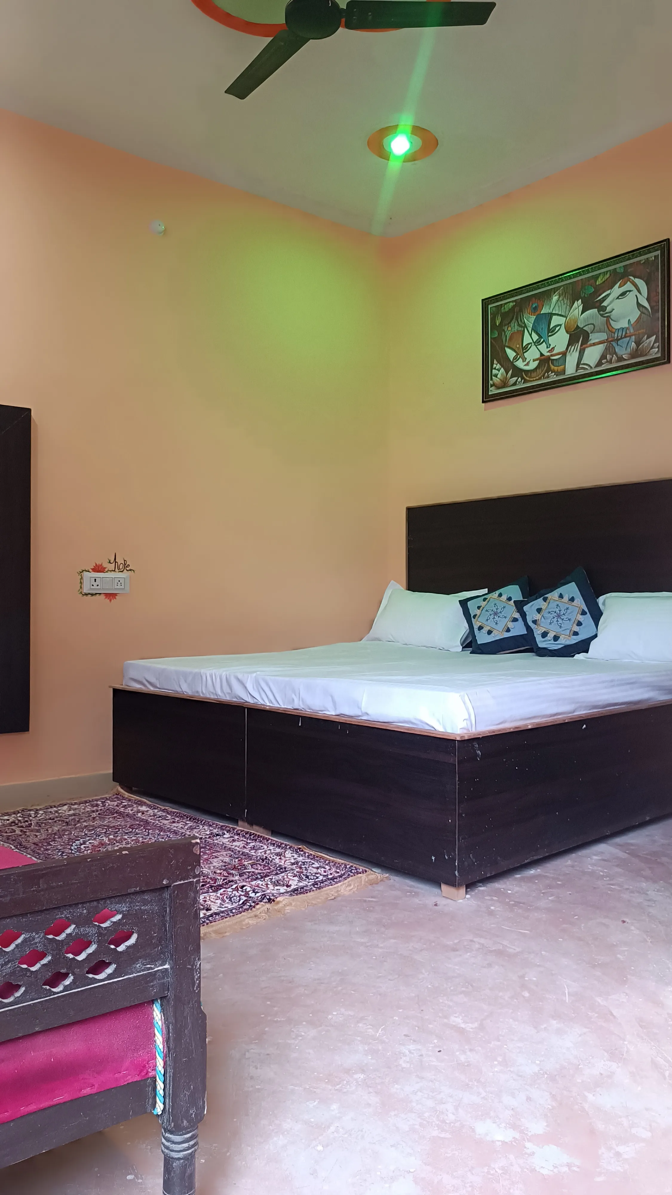 The bed and bedside area viewed from the side.