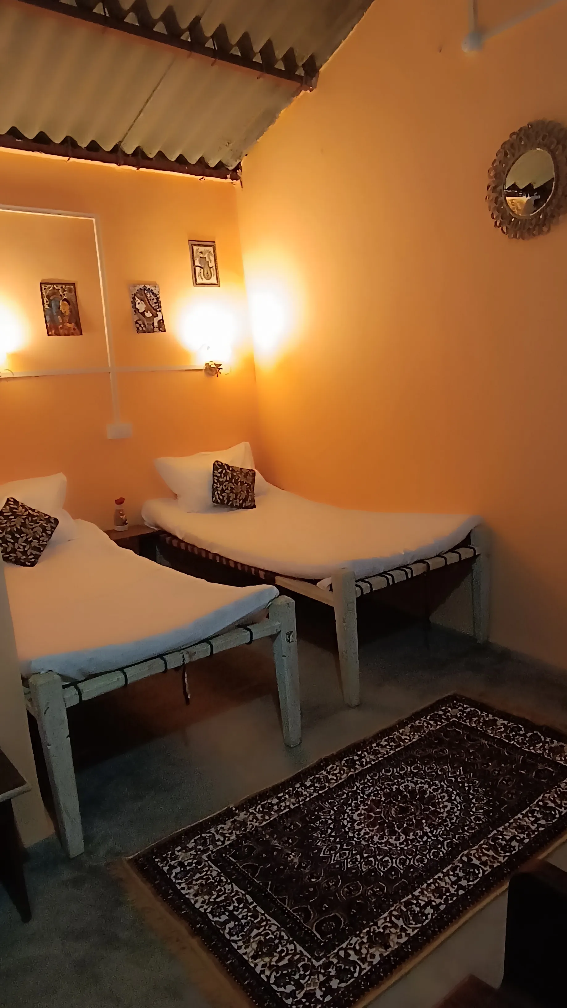Two charpai beds inside the twin hut.